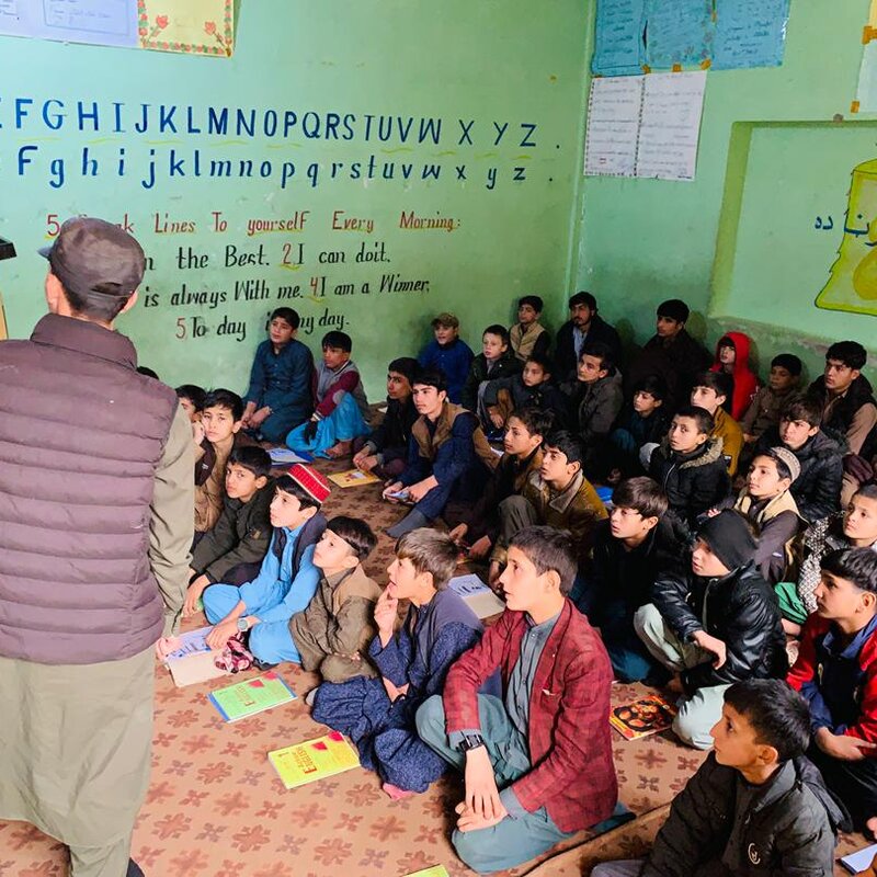 Teacher at a chalkboard leading a Zhwand class